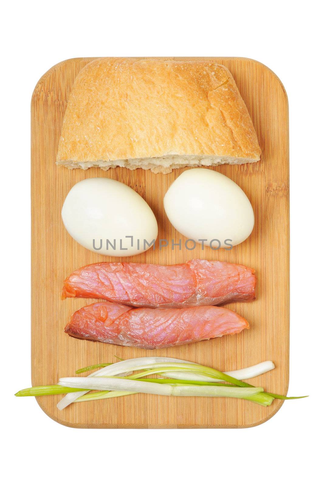 Light breakfast. Eggs, salted salmon, muffin and onion on a wooden board. Isolated on white.