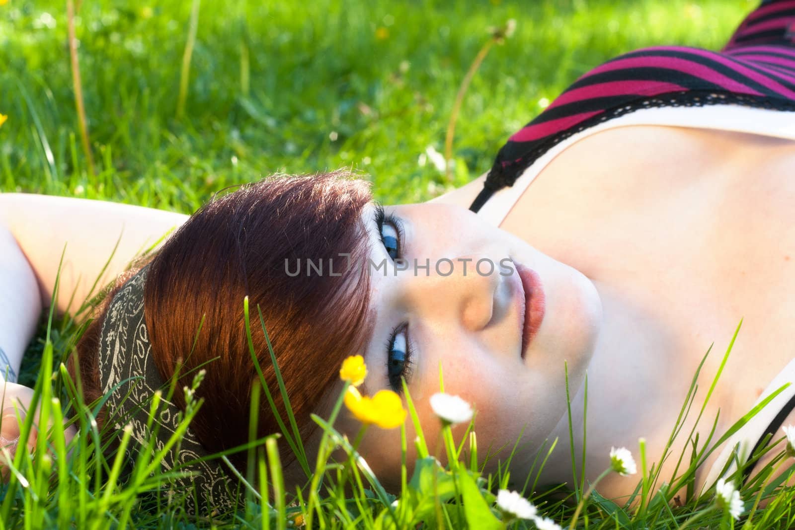 A beautiful young girl lying on the grass