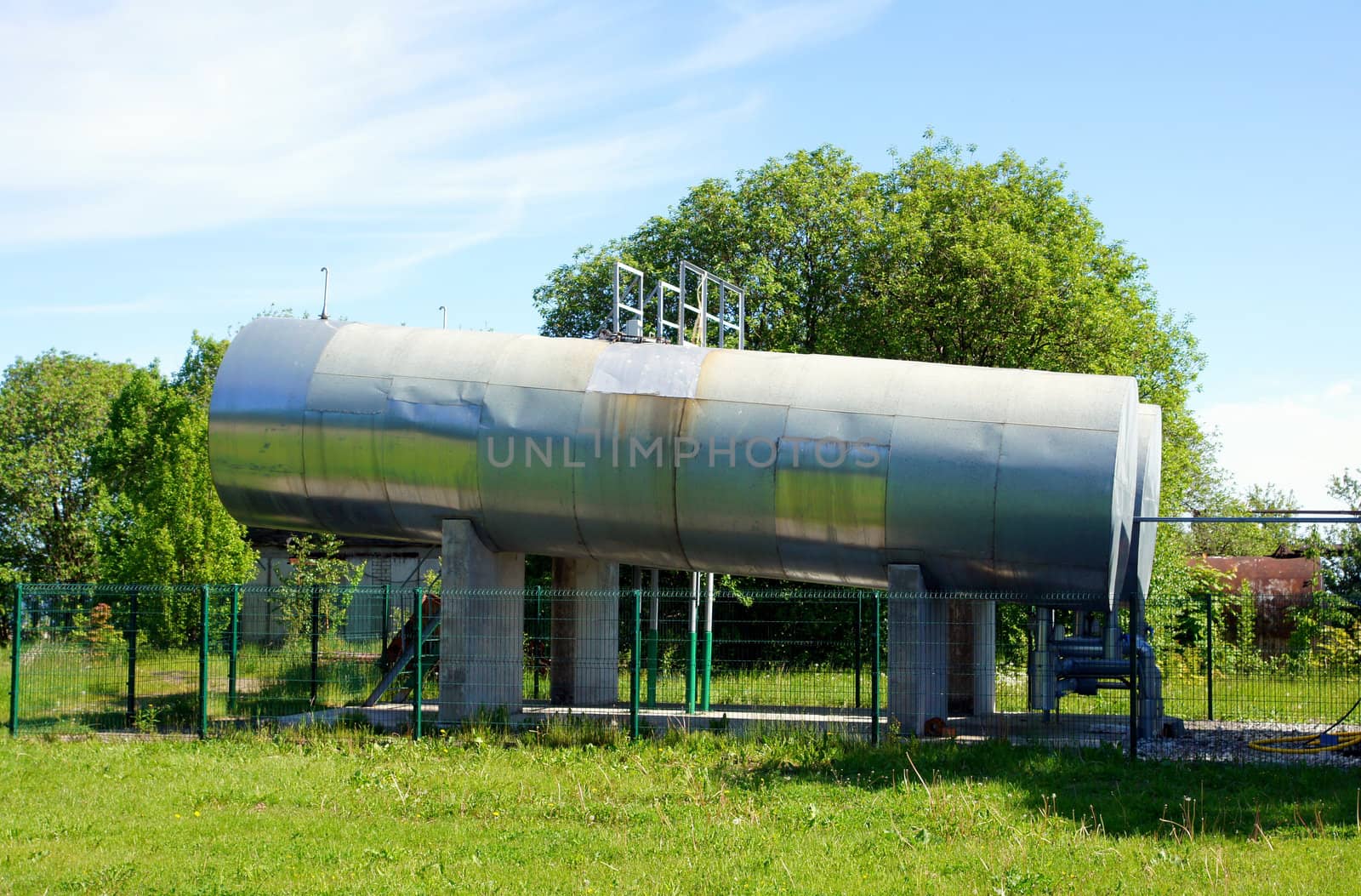 Fuel tanks on a background of plants and the blue sky