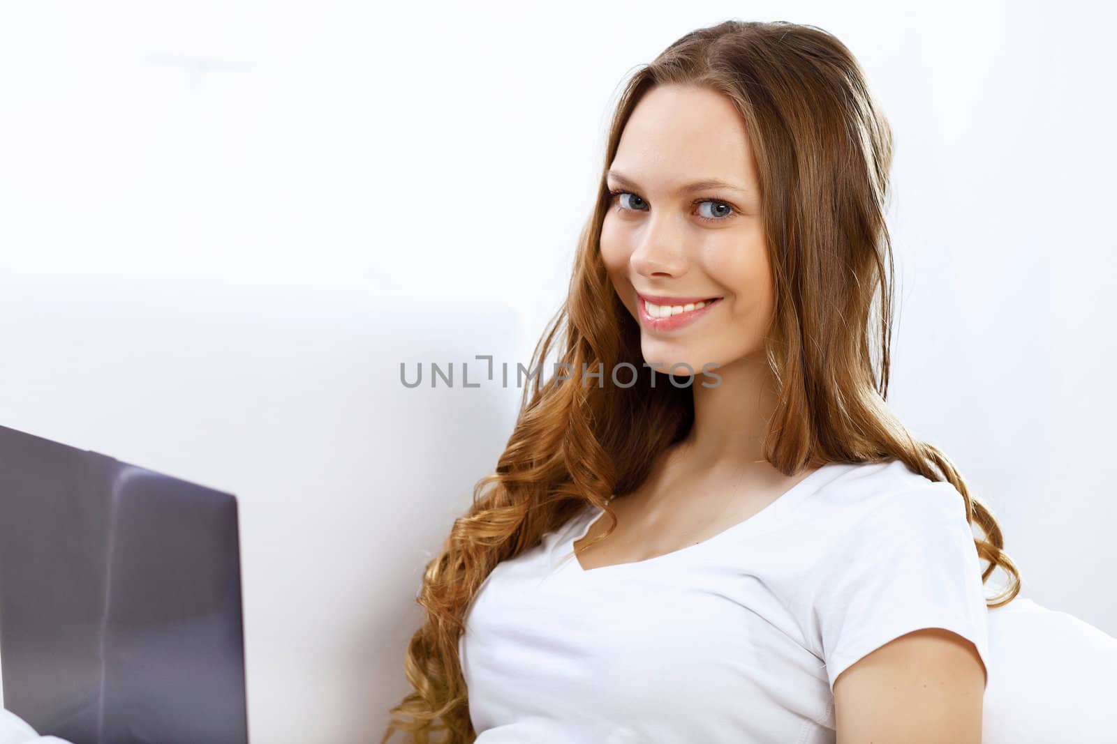 Portrait of young woman sitting with a notebook