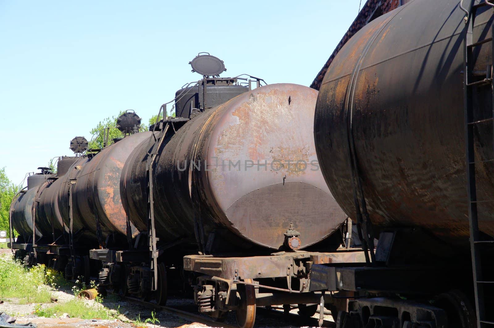 Old railway tanks on a background of the blue sky