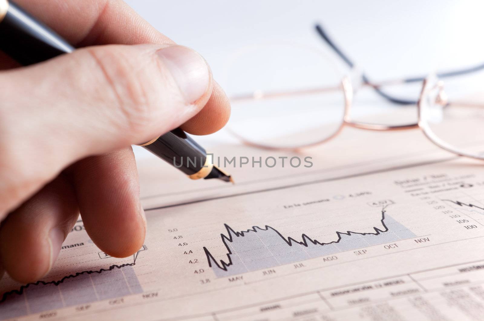 Graphics and statistics with businessman's hand
