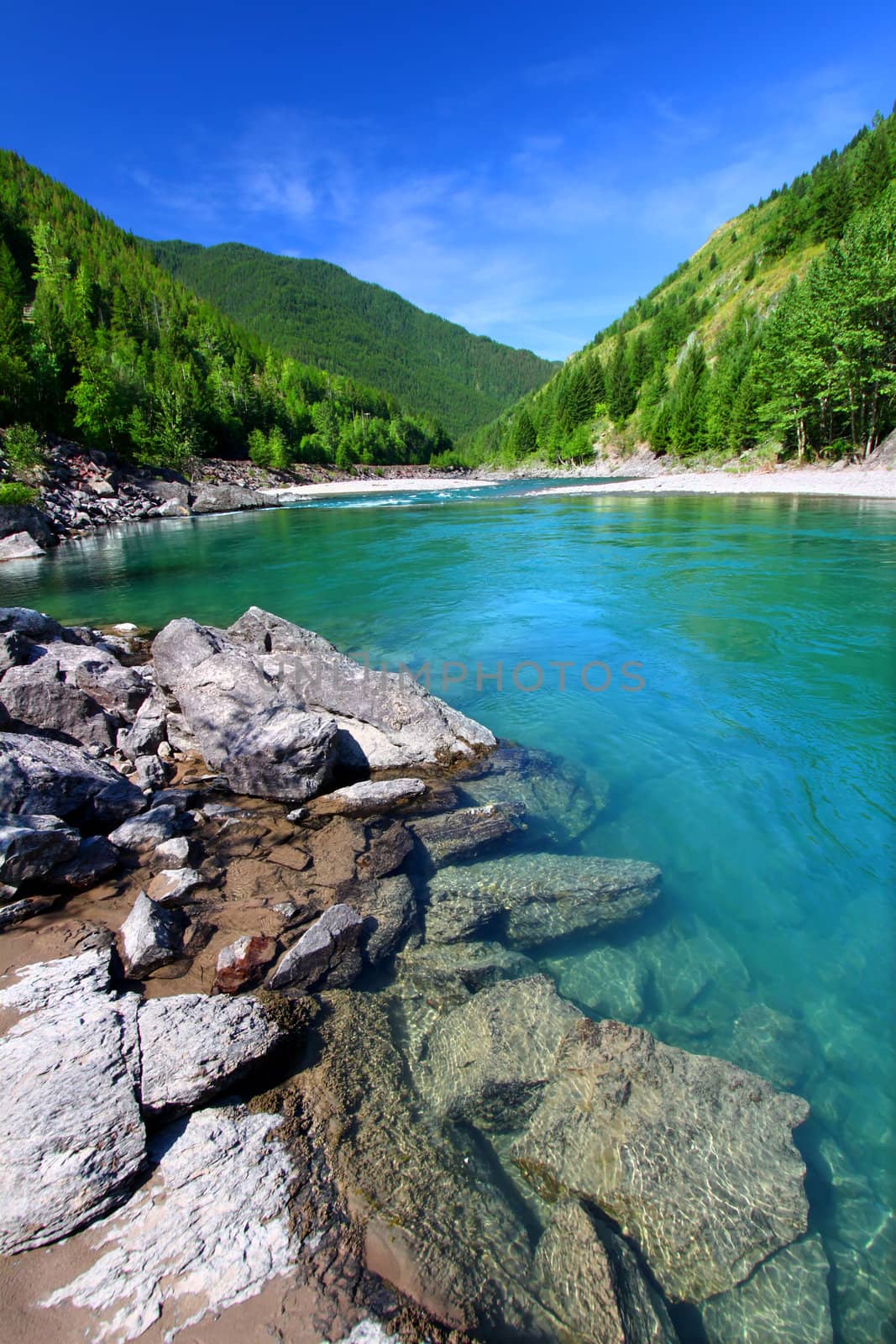Bright turquoise waters of the Middle Fork Flathead River in the Lewis and Clark National Forest of Montana.
