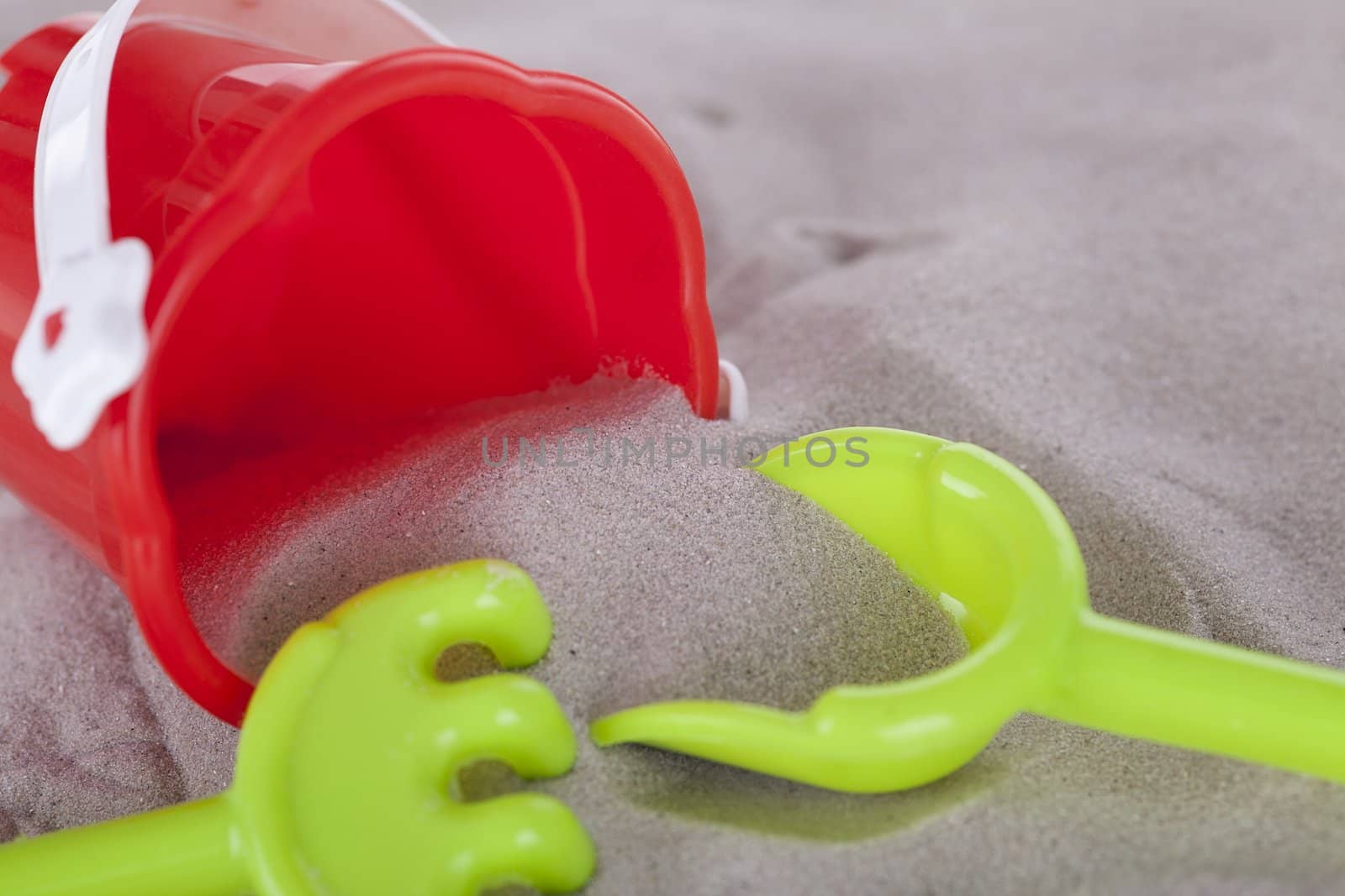 colorfull miniature toys in sand on beach in summer