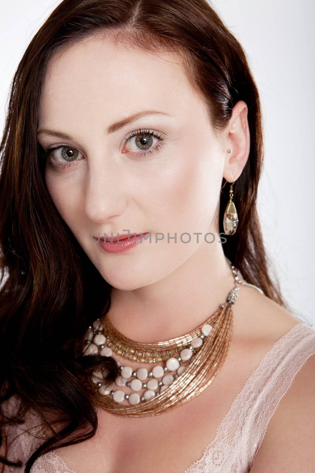 portrait of a young beautiful woman with jewellery isolated