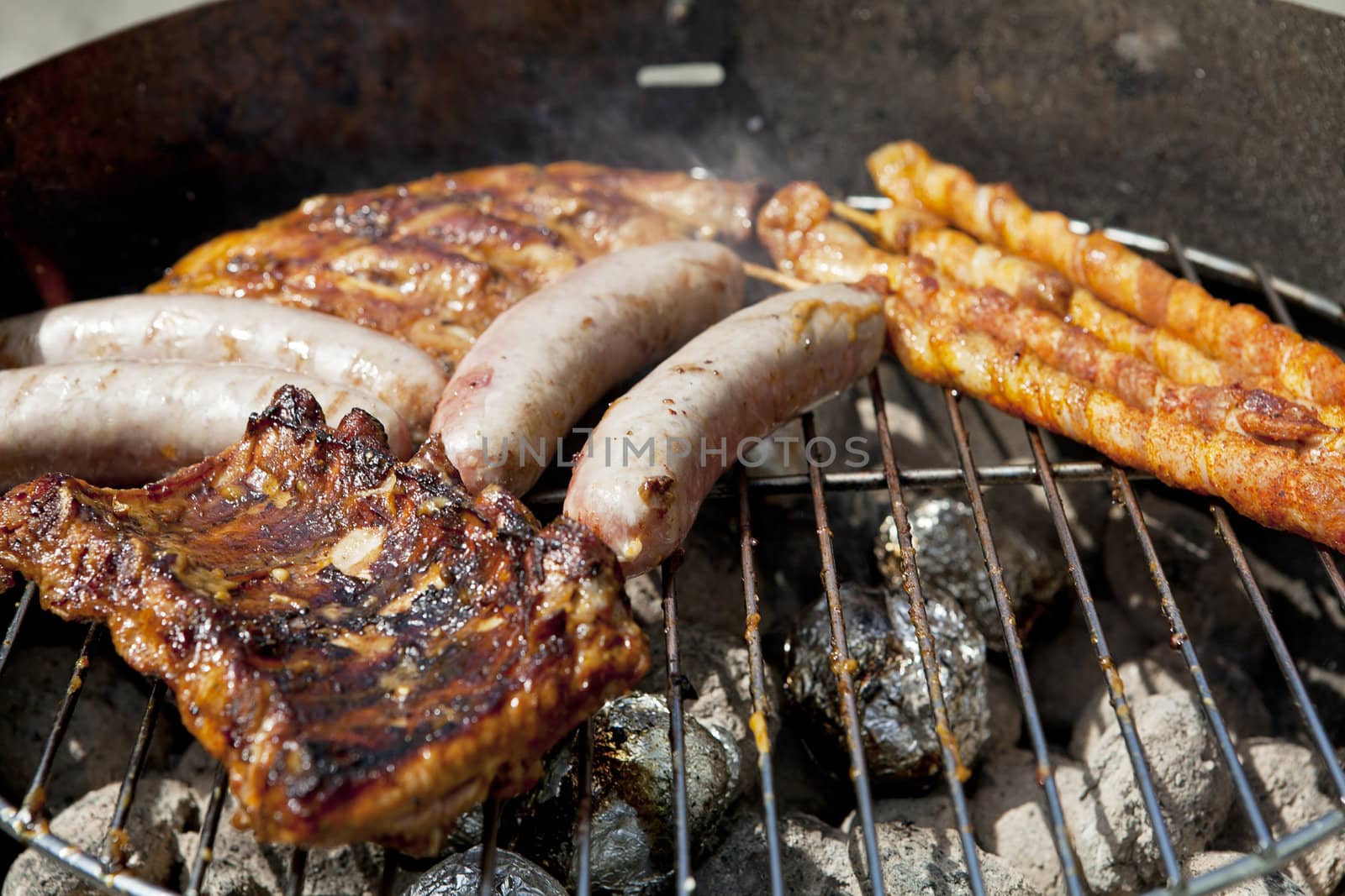 barbecue grill wiht meat and vegetables outside in summer