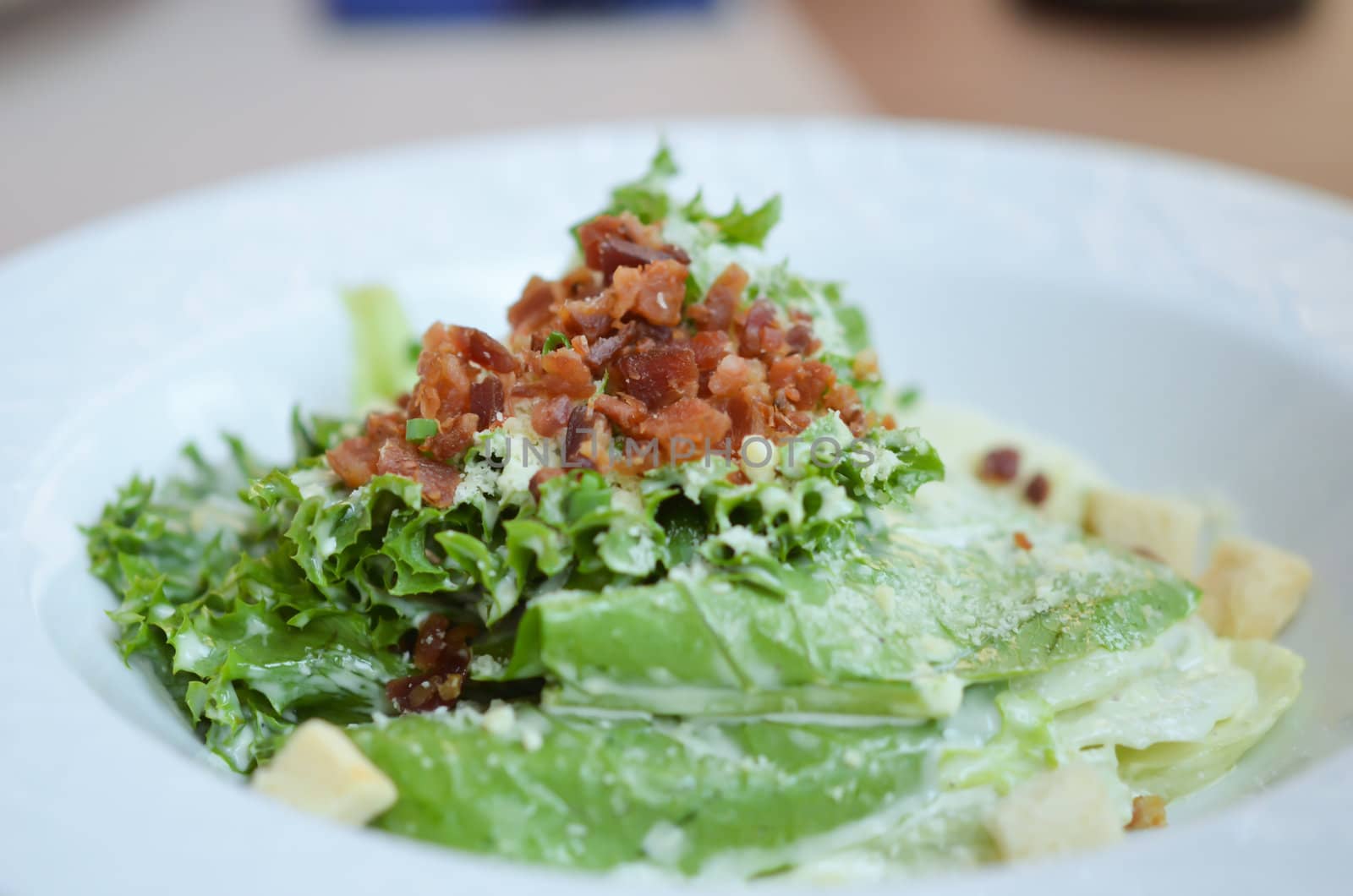 white bowl of caesar salad , fresh and delicious