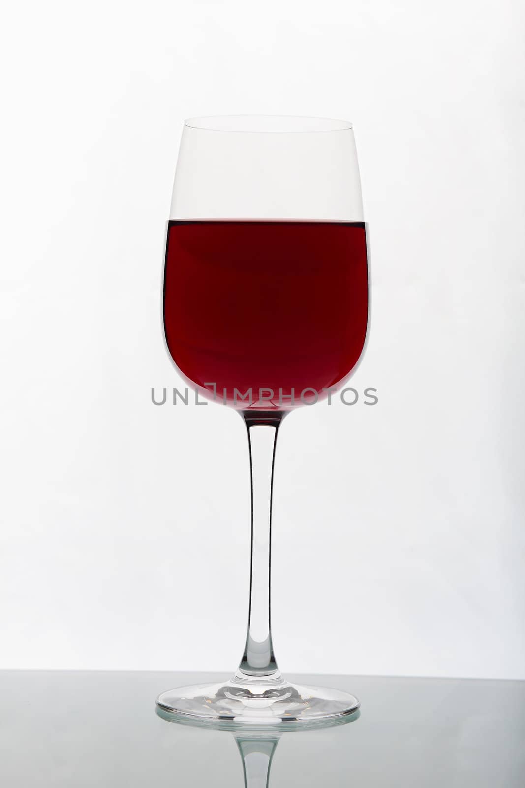 Glasses with wine on the color background