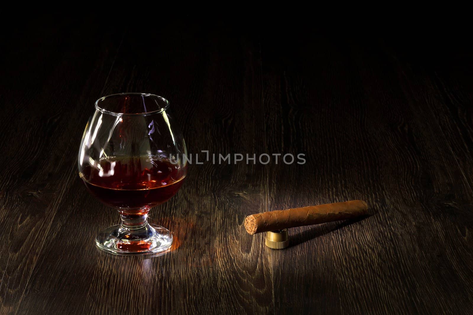 Cognac, cigar and an old book nearby by sergey_nivens