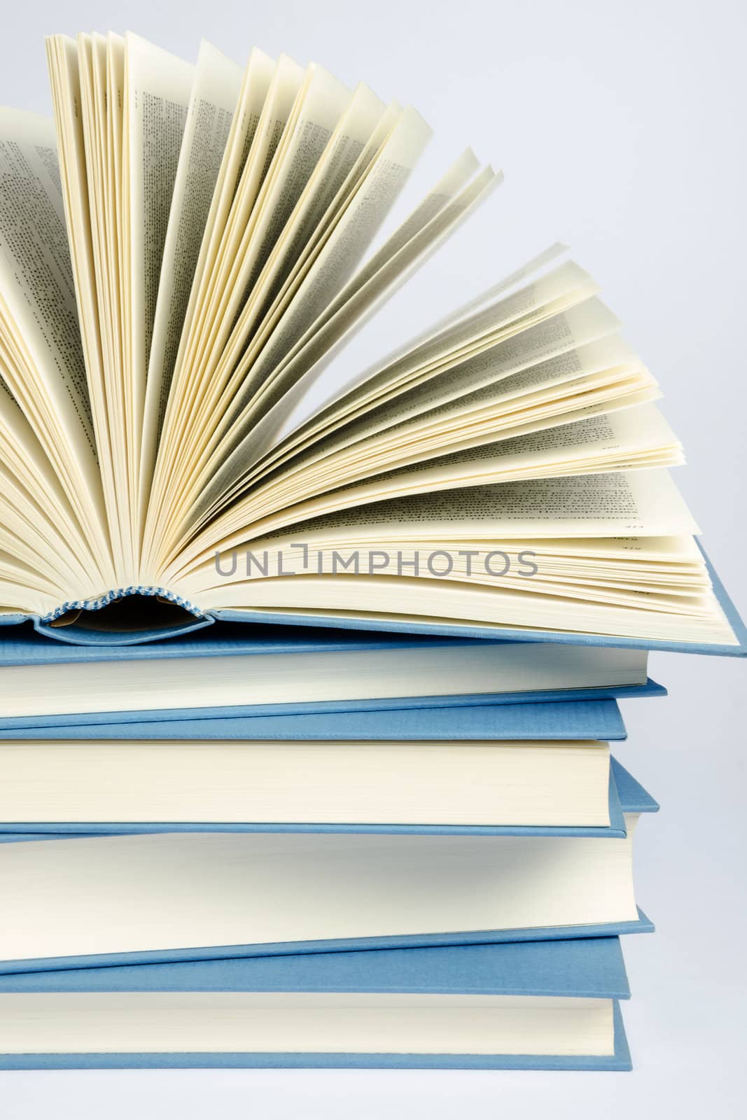 A stack of blue books on light blue background