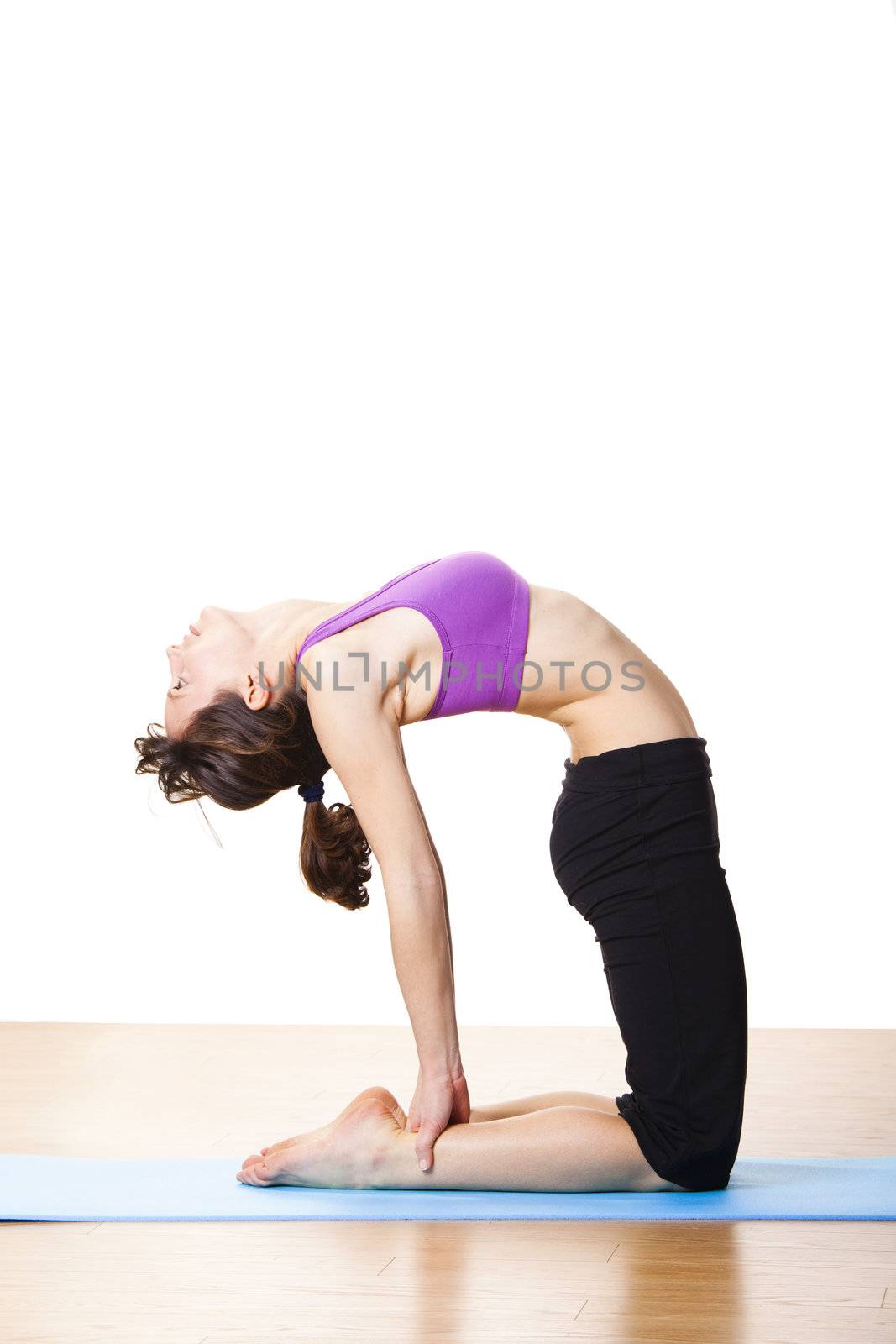 Beautiful and athletic young woman doing yoga exercises