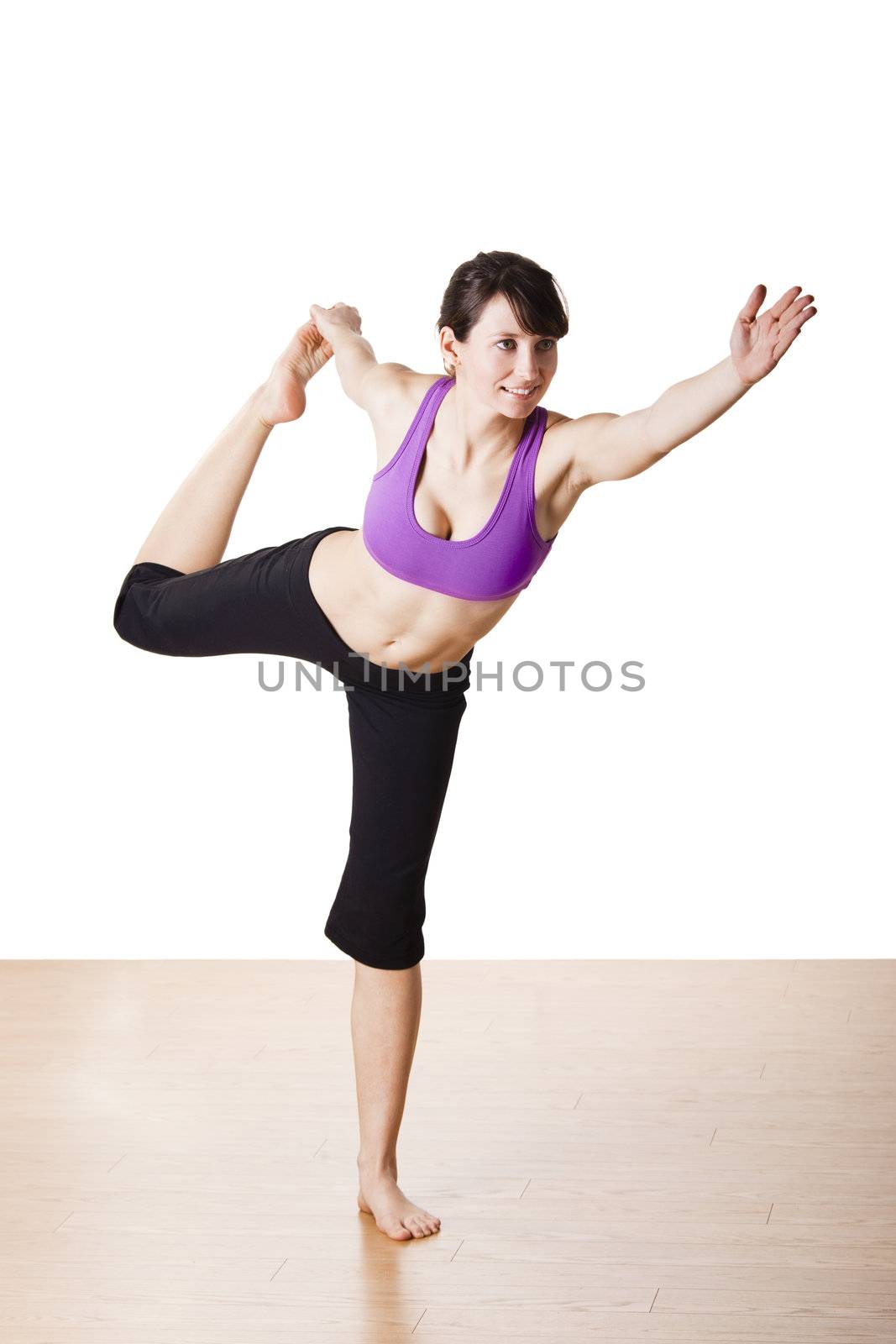 Beautiful and athletic young woman doing yoga exercises