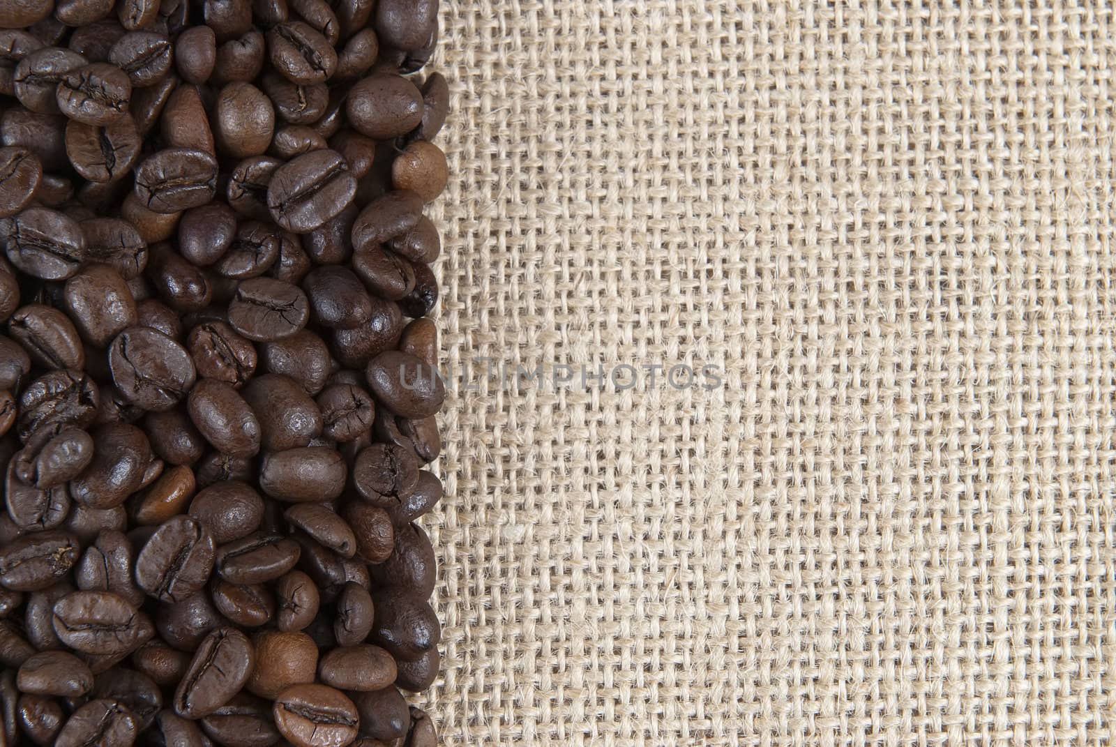 Burlap background with coffee beans. by angelsimon