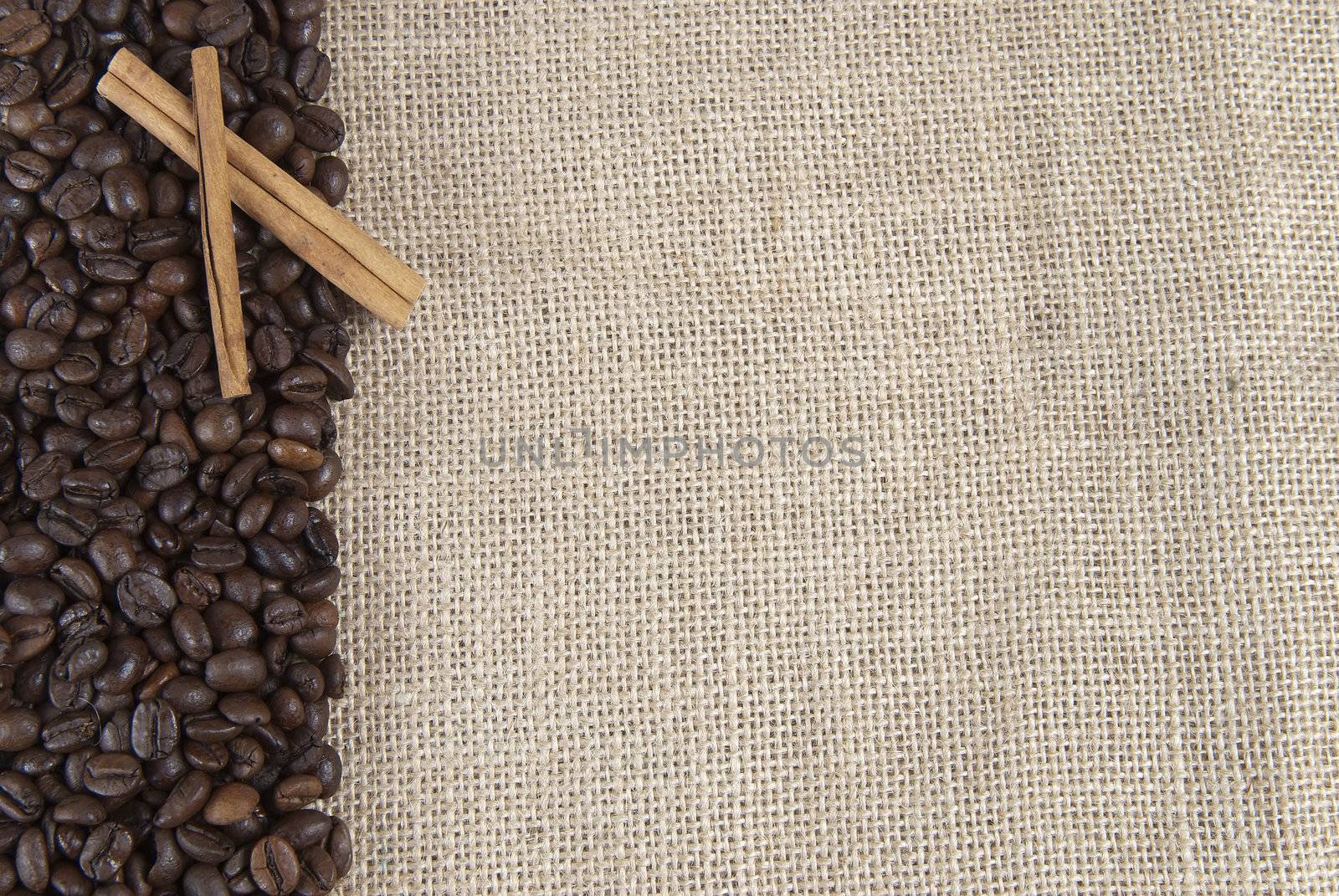 Background of burlap and coffee beans with a copy space.