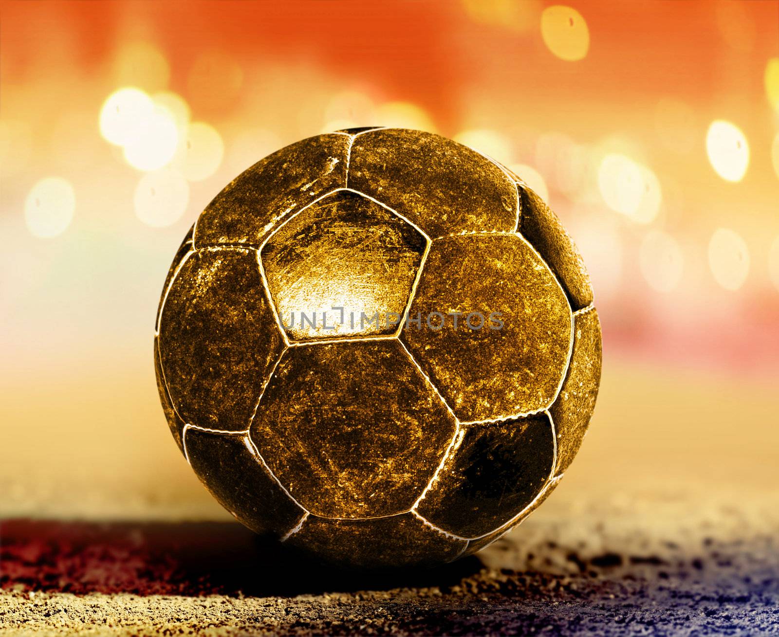 golden soccer ball on ground of football field