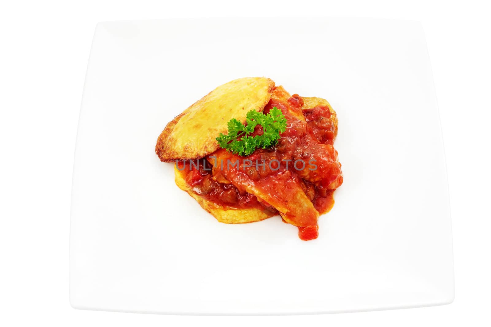 dish of hake with tomato sauce on a bed of potatoes cut off and isolated