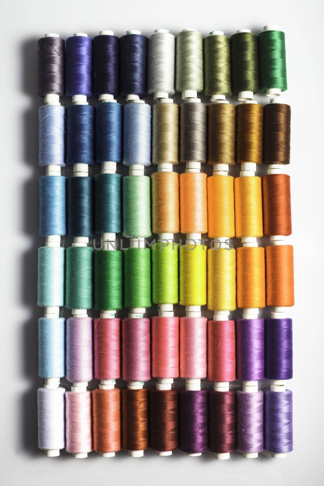 Sewing threads as a multicolored background closeup