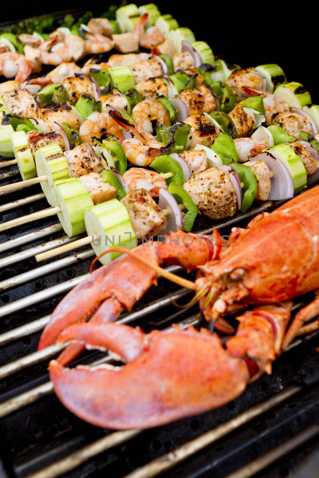 Salmon Skewers and Lobster are on the barbecue.