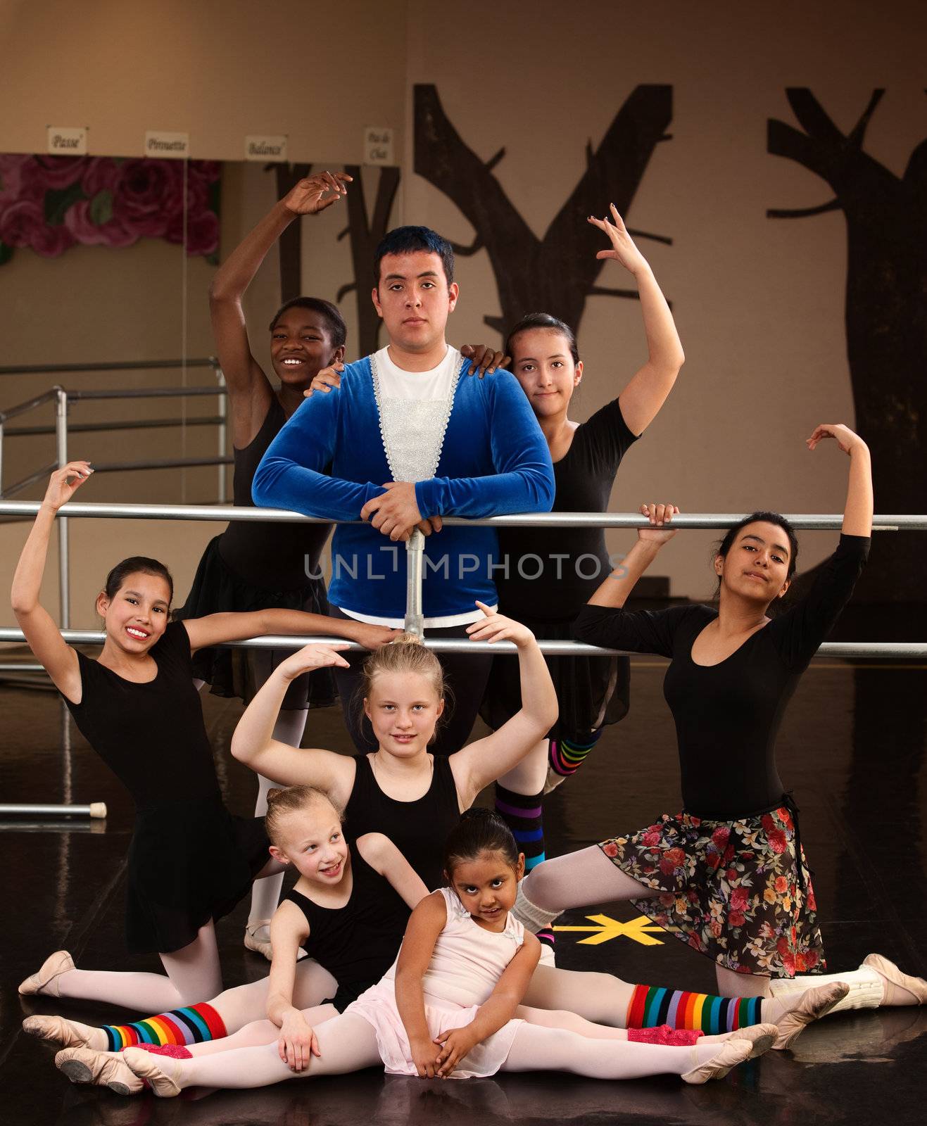 Group of ballet students with teacher in studio