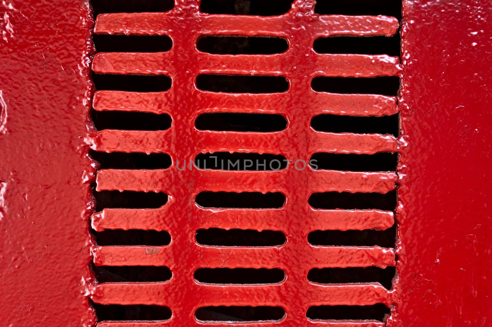 Old metal lattice with vents, painted with red paint