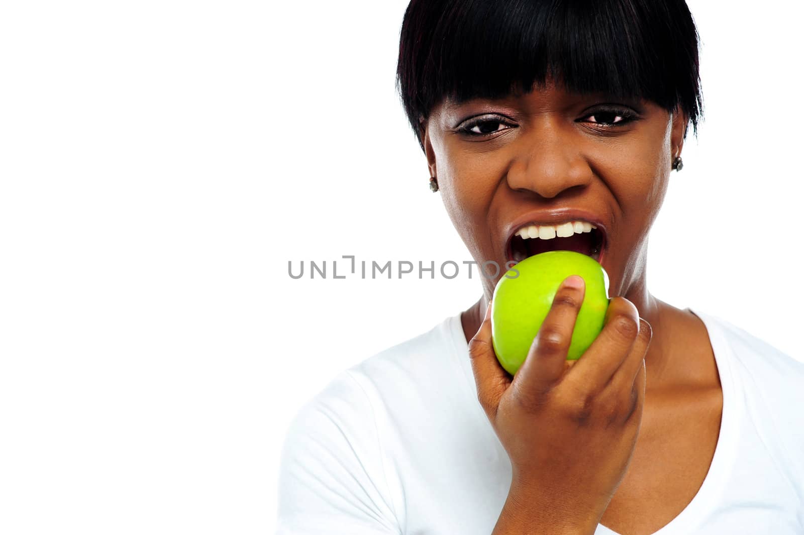 Close up shot pretty lady eating green apple in front of camera