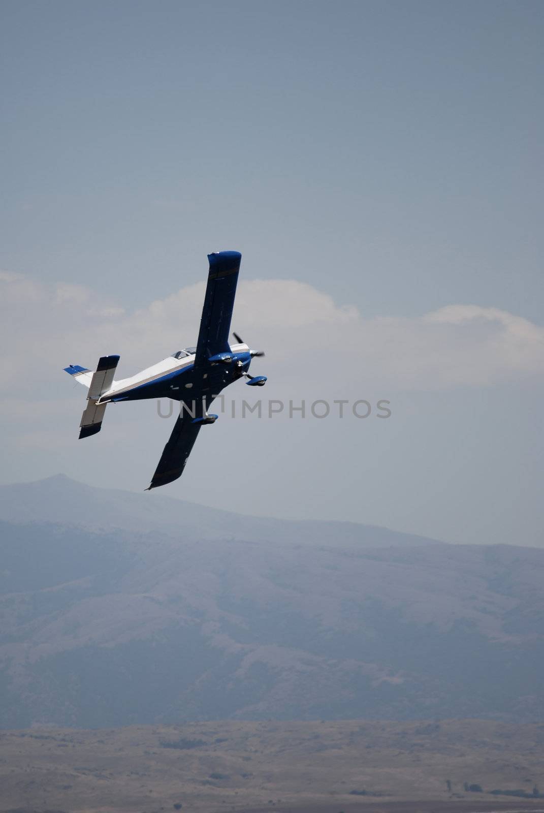 A blue and white plane on the horison