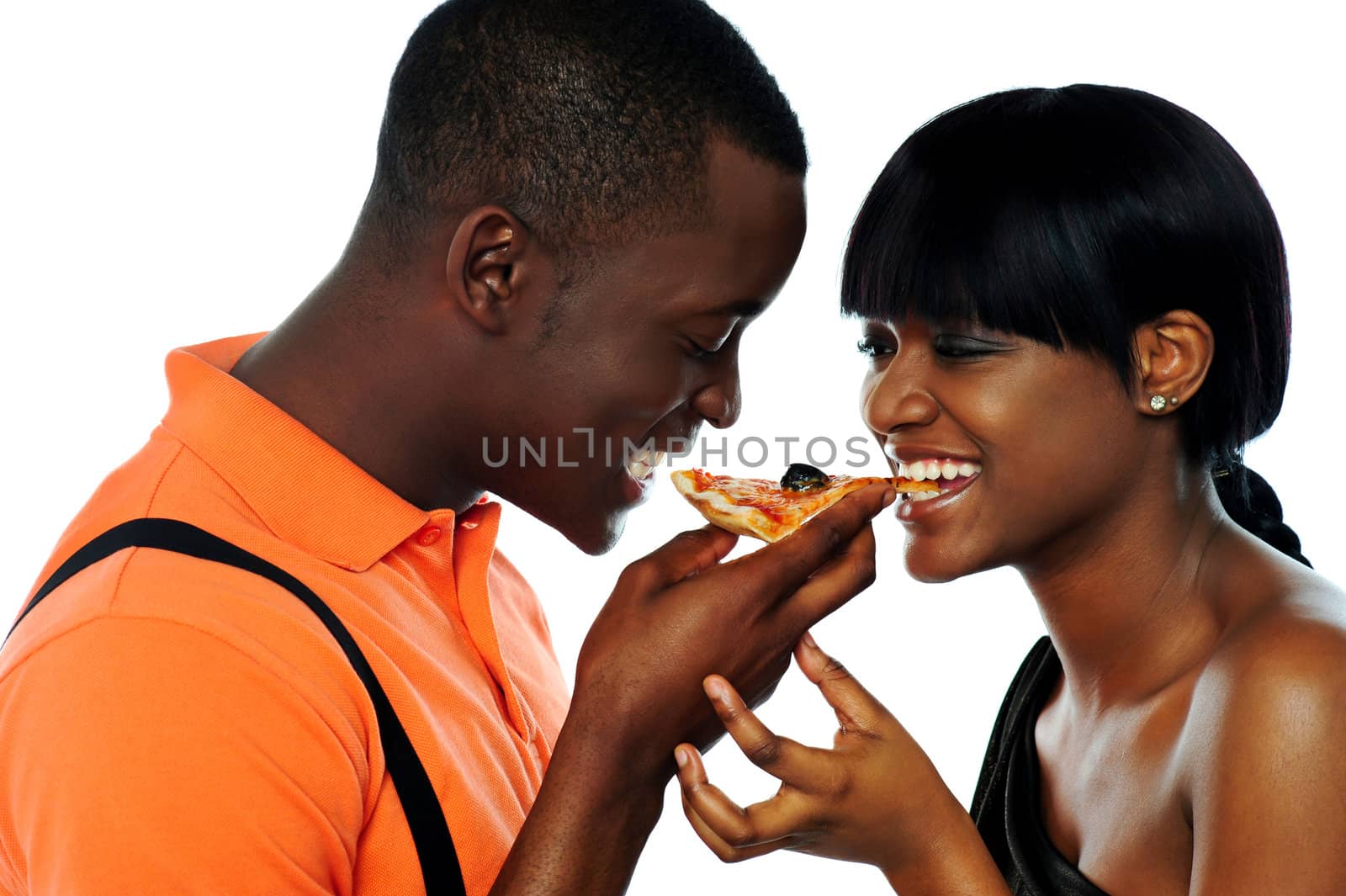 Young couple sharing a slice of pizza isolated over white background