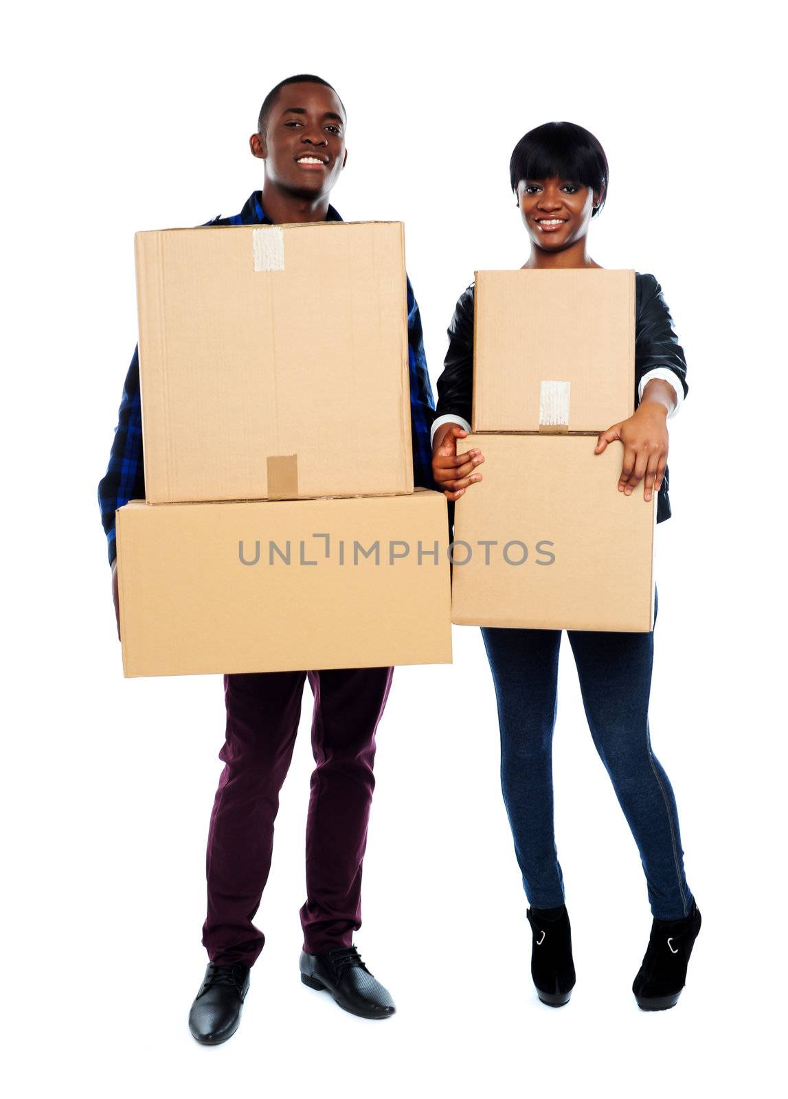Smiling young couple holding cardboard boxes. Moving to a new place
