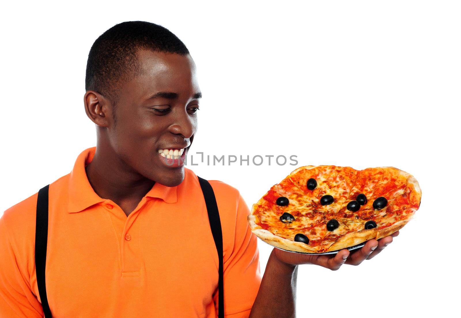 Smiling young black man holding yummy pizza against white background