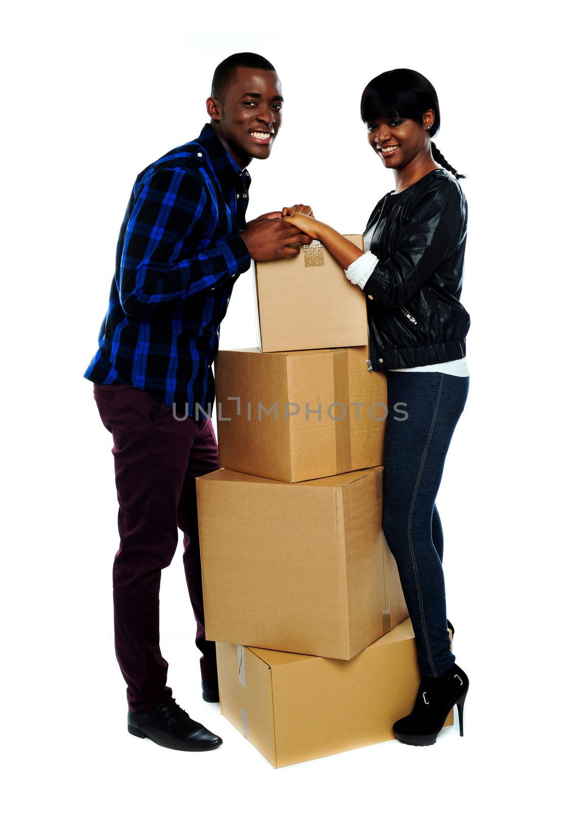 African couple standing on either side of boxes and holding hands