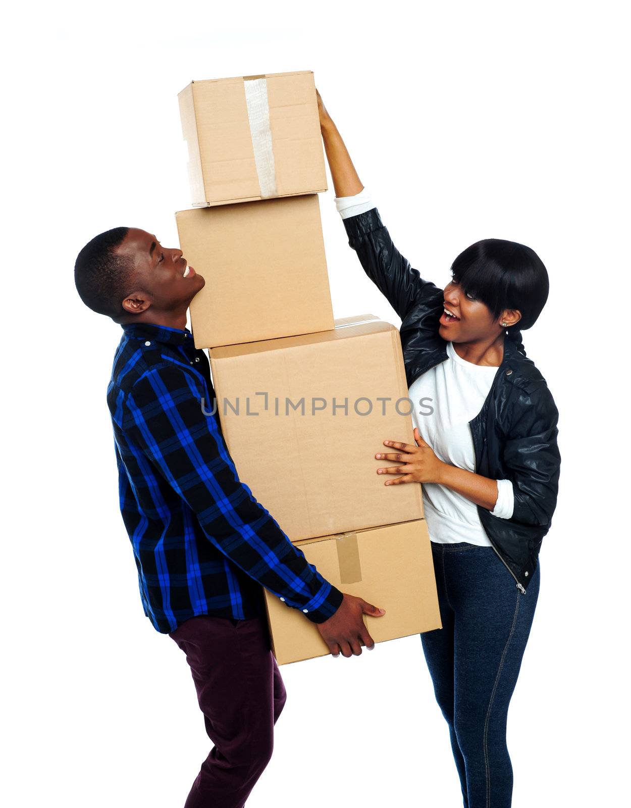Teenage couple with cardboard boxes. Girl trying to make stack high