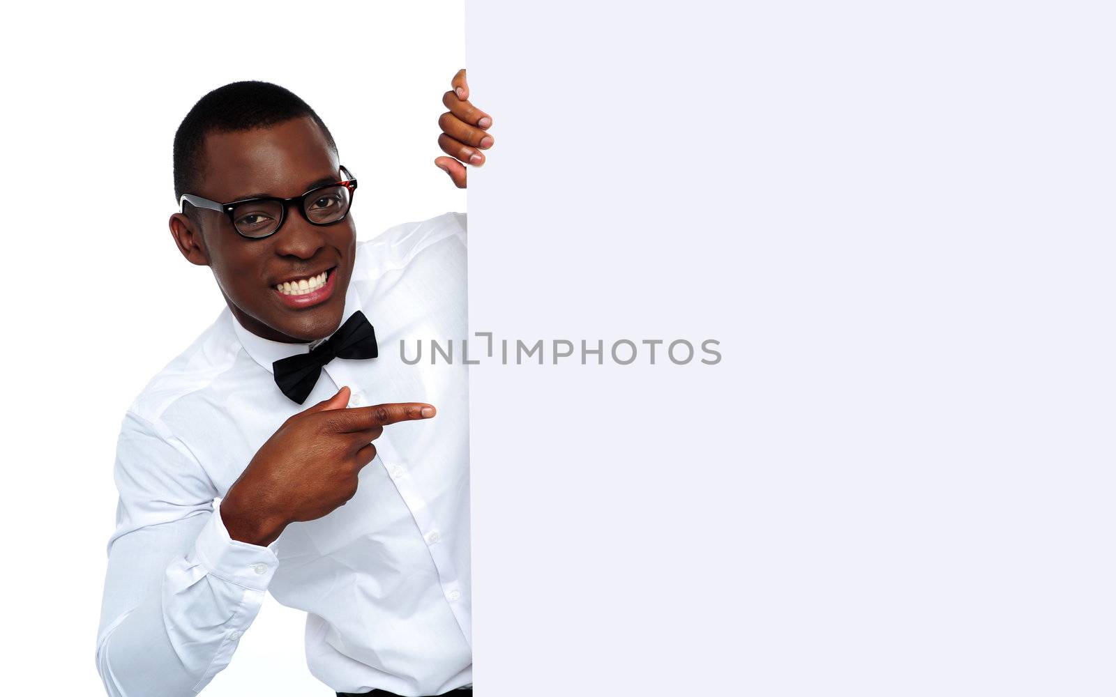 Black man pointing at blank placard by stockyimages