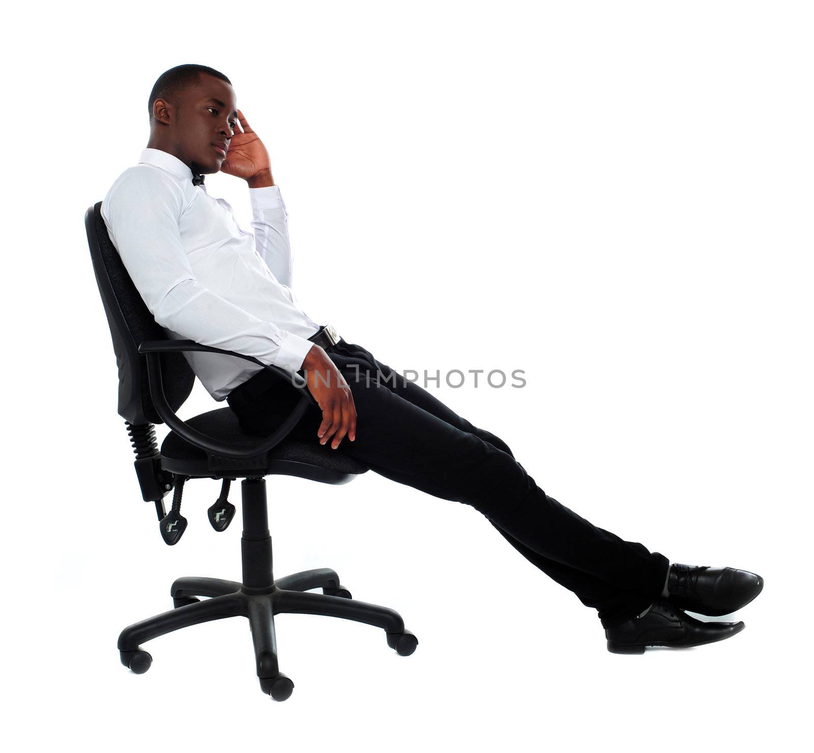 Portrait of thoughtful young businessman sitting on chair