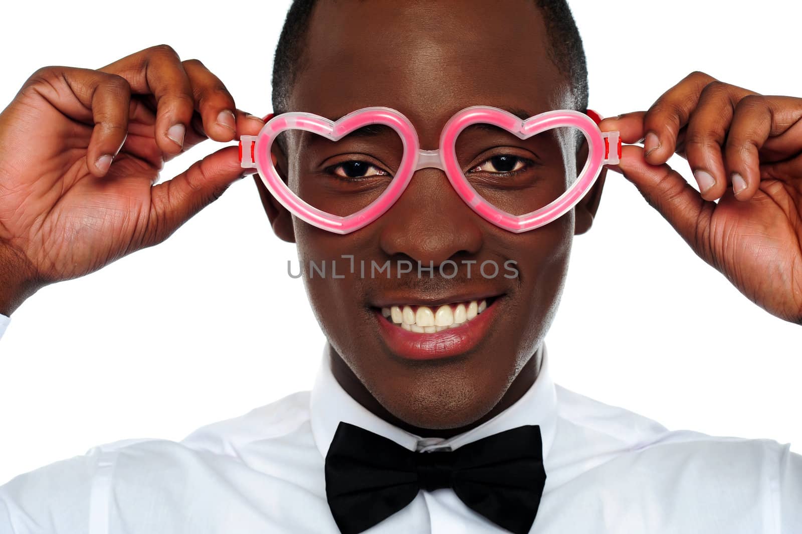 Smiling man wearing heart shaped eye-wear. Love and funny concept