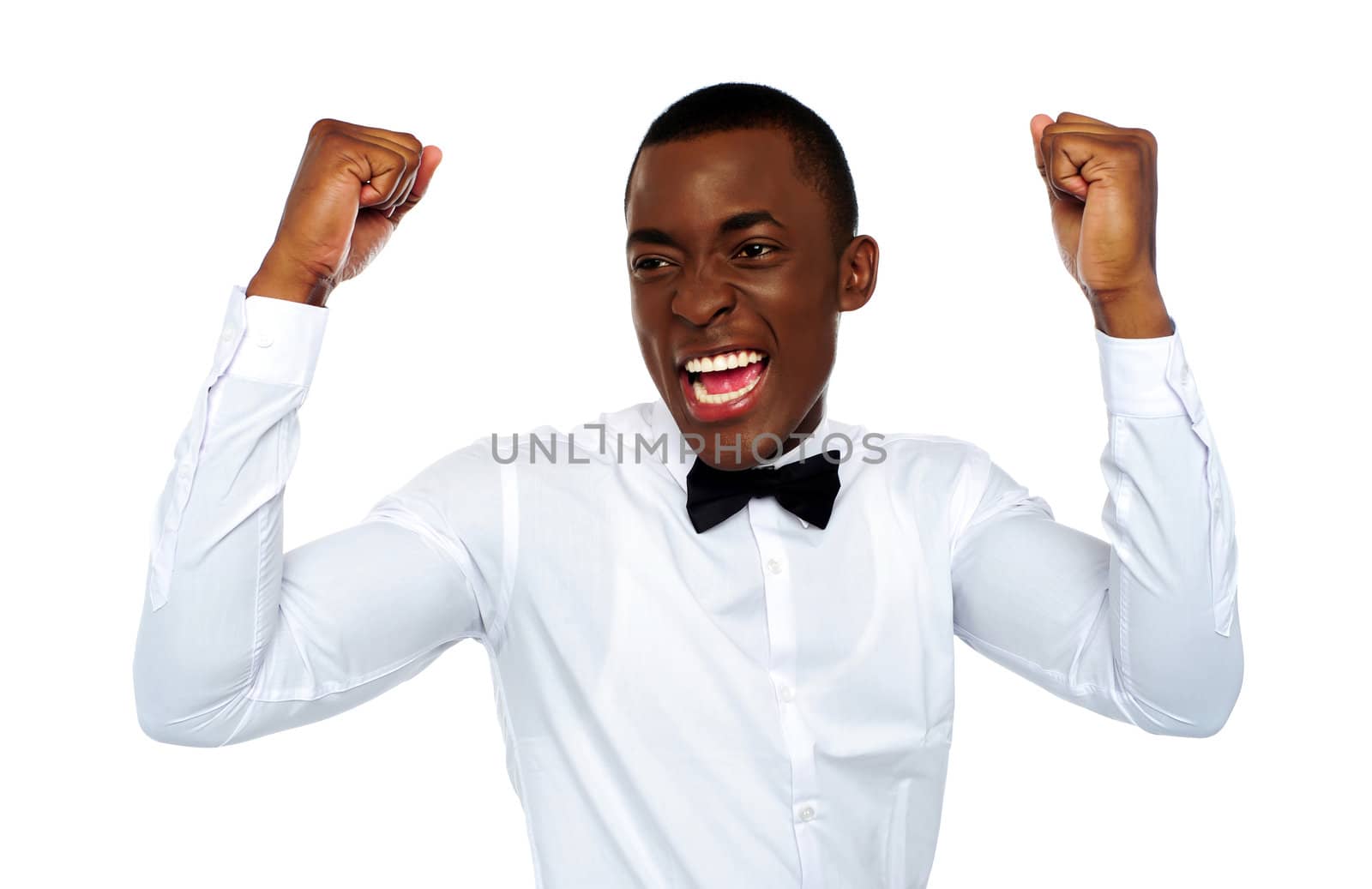Excited african man enjoying his success by stockyimages