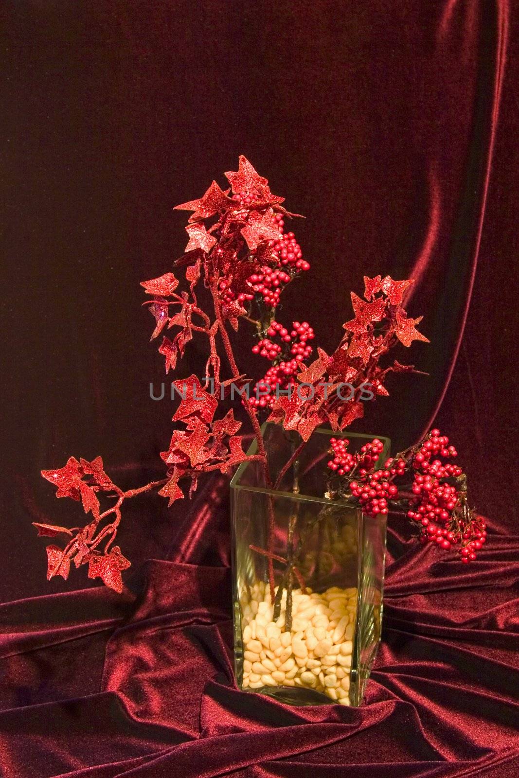 still life in red tones with vase in modern style, fabric and whimsical plants