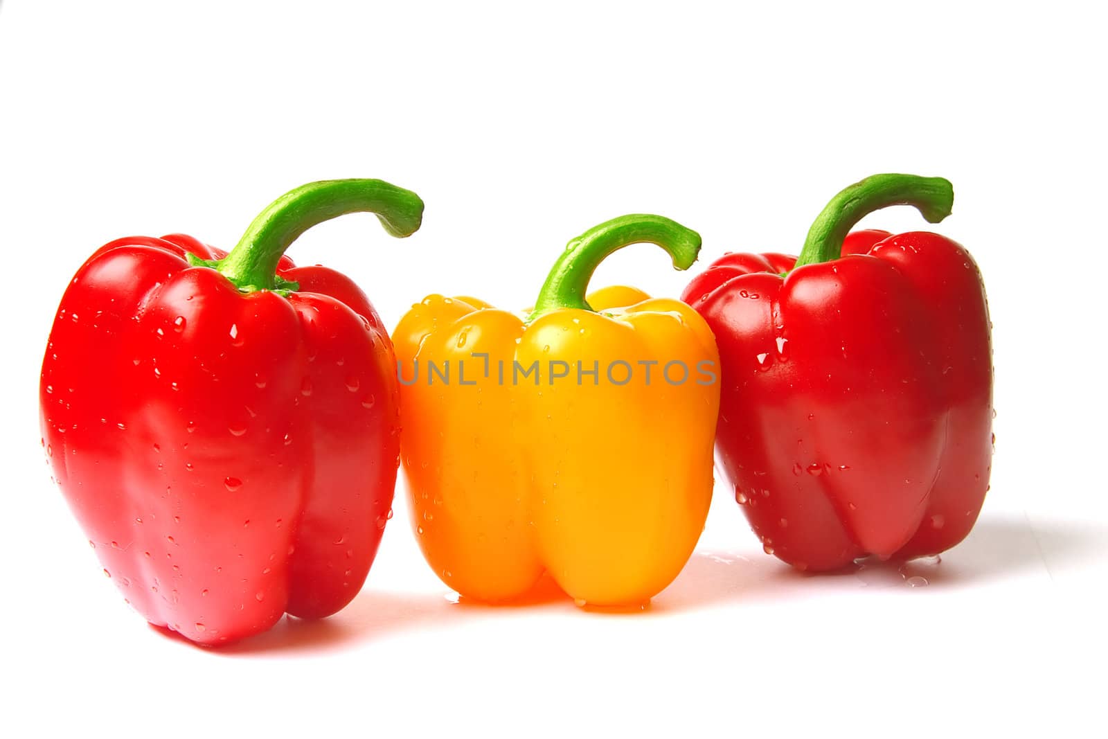 excellent red and yellow peppers the covered drops of water on a white background