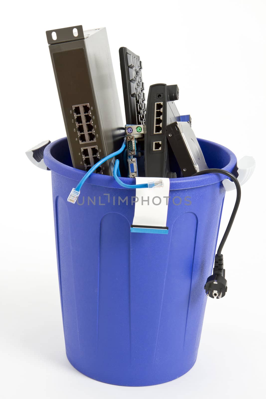 electronic scrap in trash can. keyboard, cables, logicboard, hard drive - isolated on white background