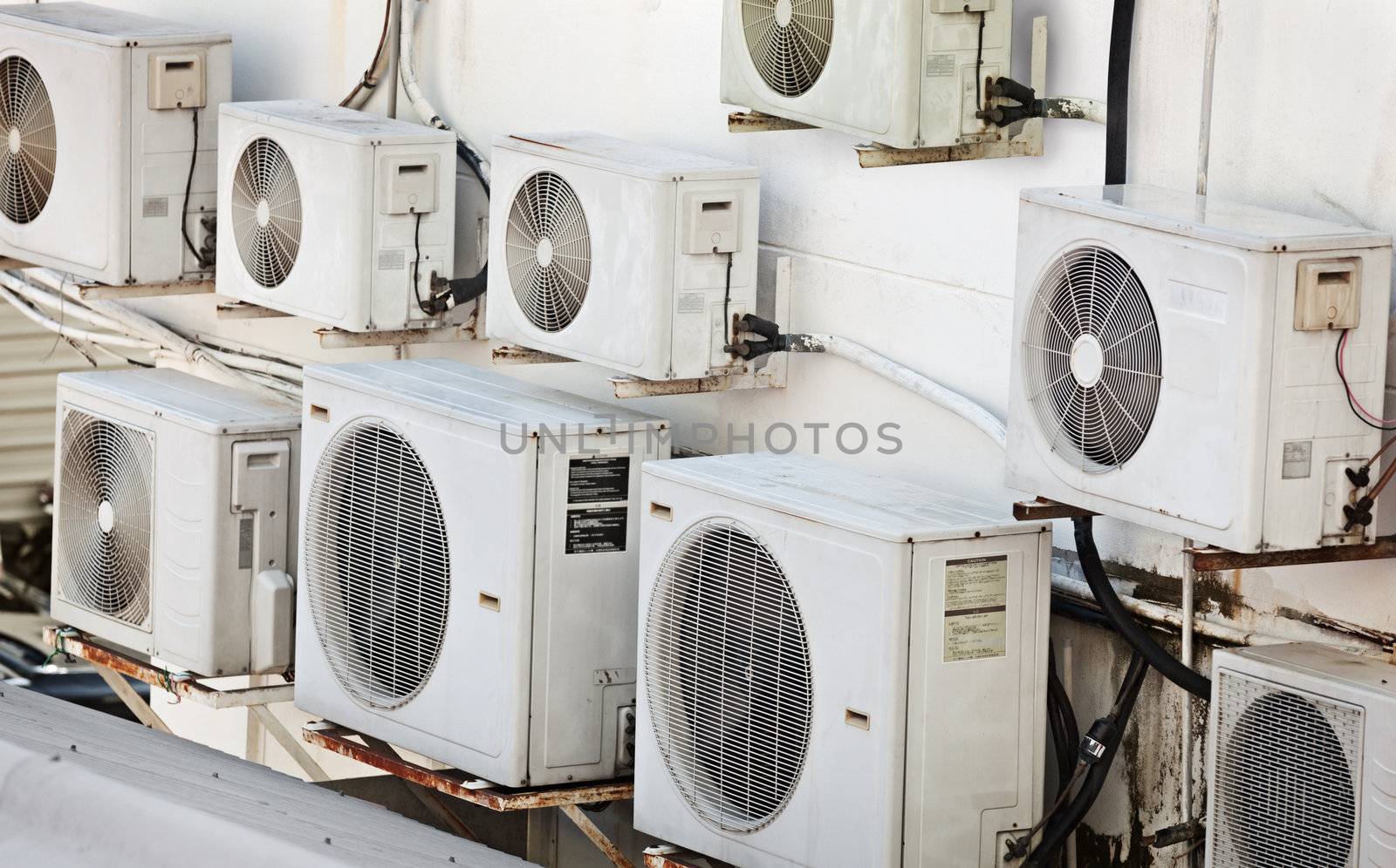 Many older air conditioners on the wall by pzaxe