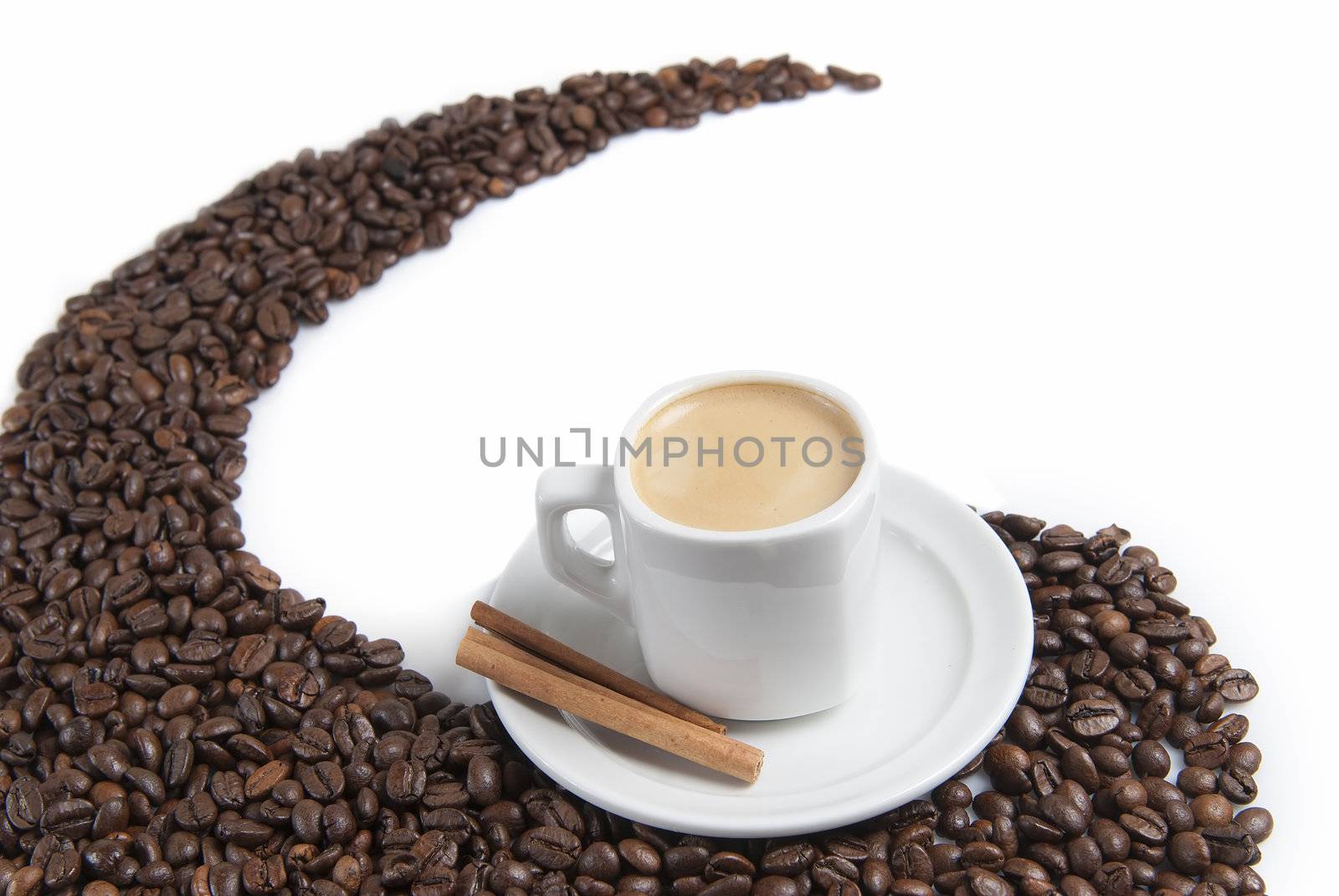 Still life about coffee with a delicious  espresso and some coffee beans and cinnamon.