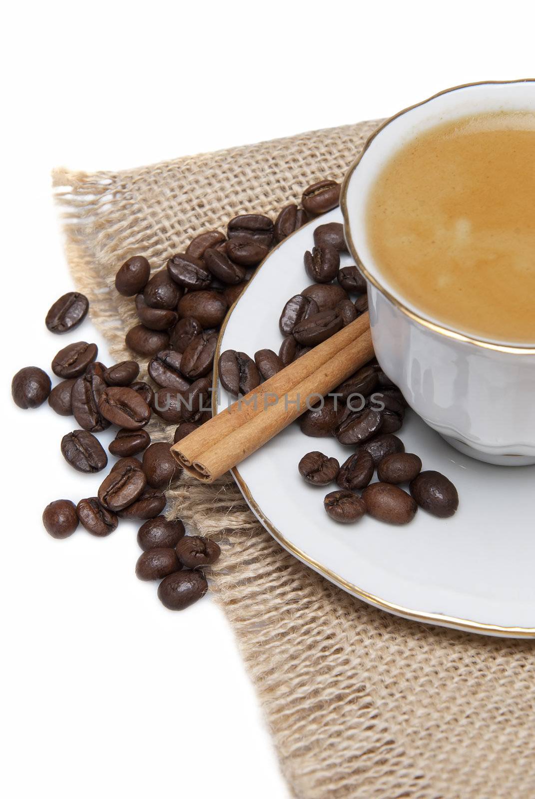 Still life about coffee with a delicious  espresso and some coffee beans and cinnamon.