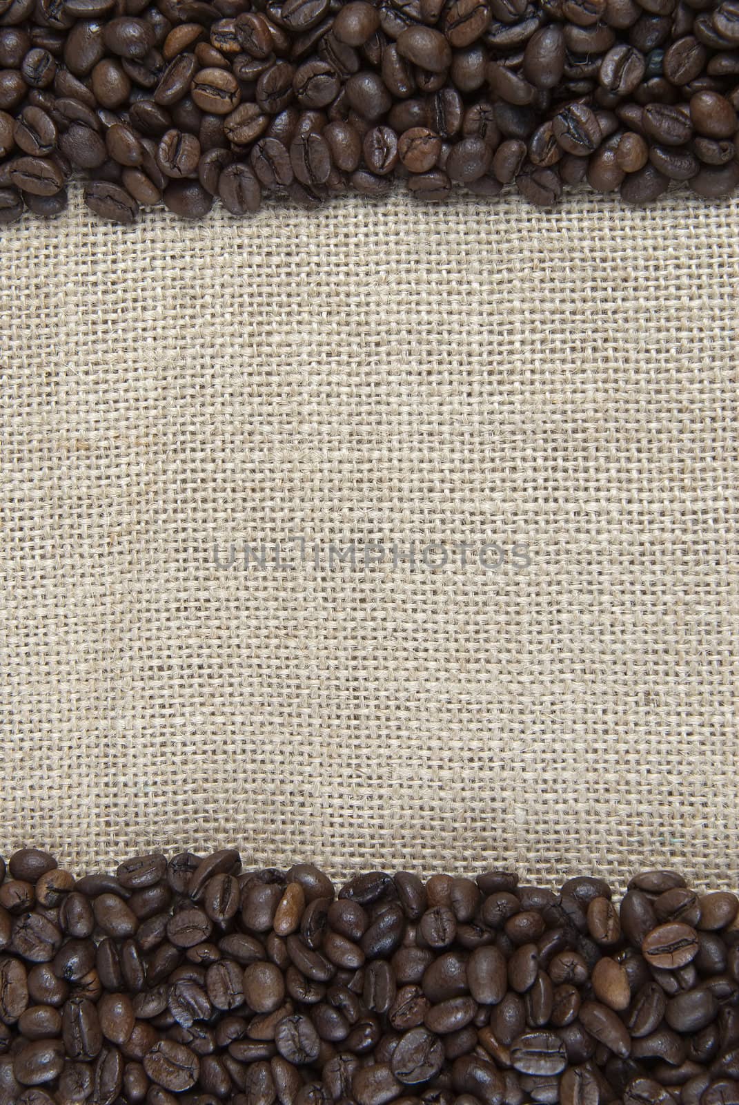 Background of burlap and coffee beans with a copy space.