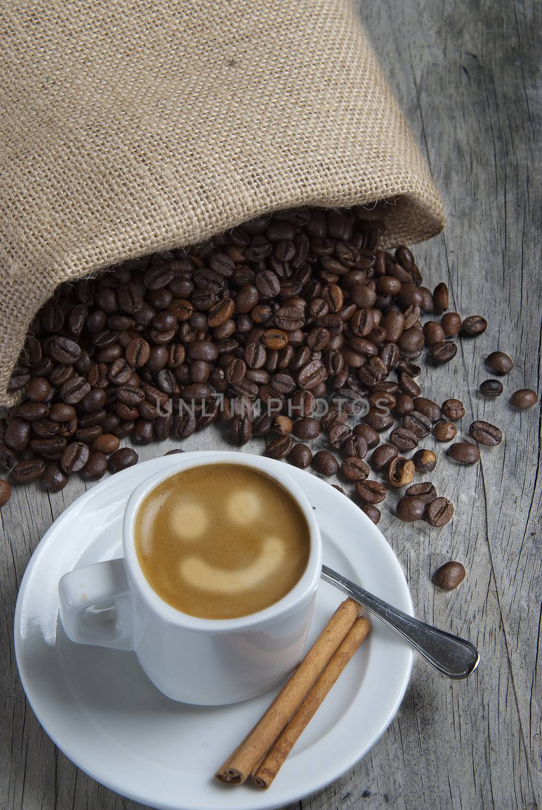 Still life about coffee with a delicious  espresso and some coffee beans and cinnamon.