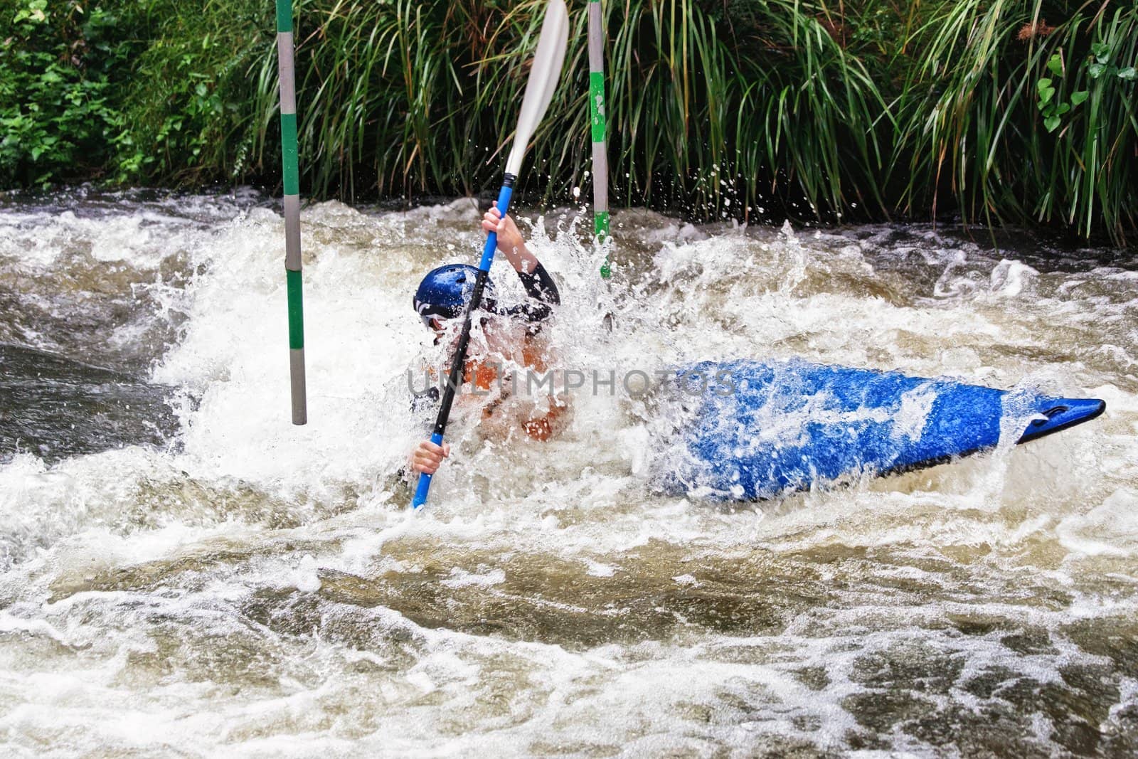 teenager white water kayaking in the rapids