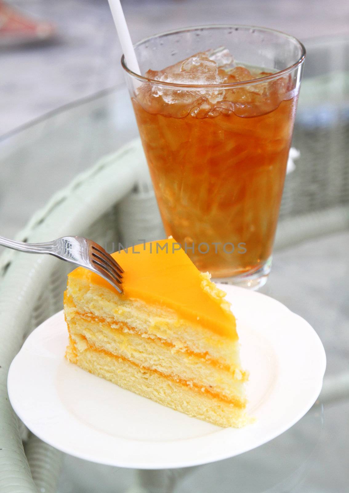 Delicious orange cake with iced tea  by nuchylee
