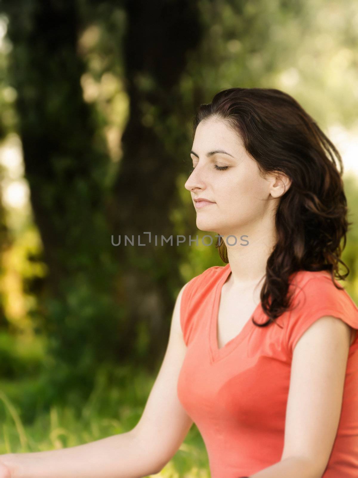 Young women trying a breathing exercise in nature