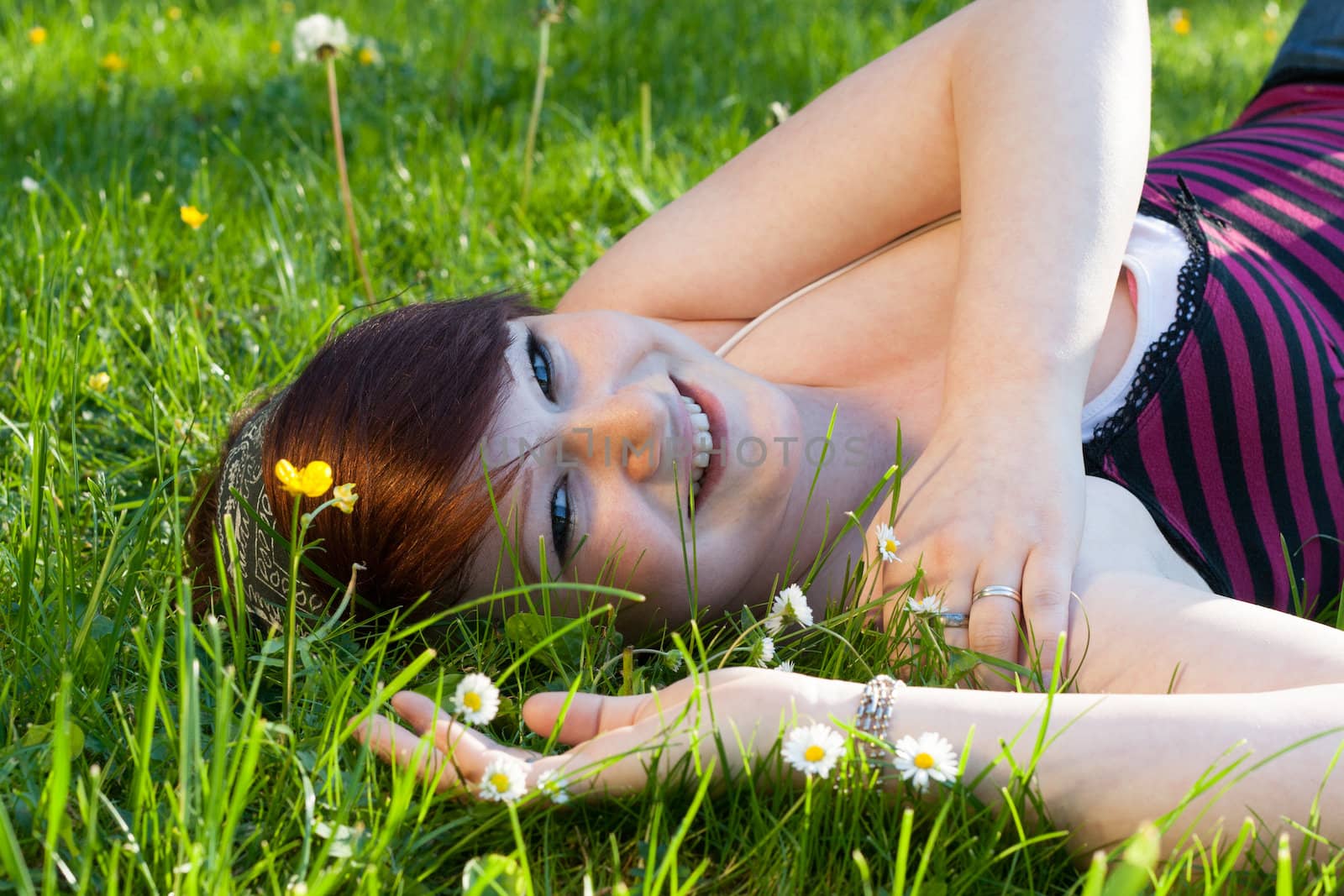 A beautiful young girl lying on the grass