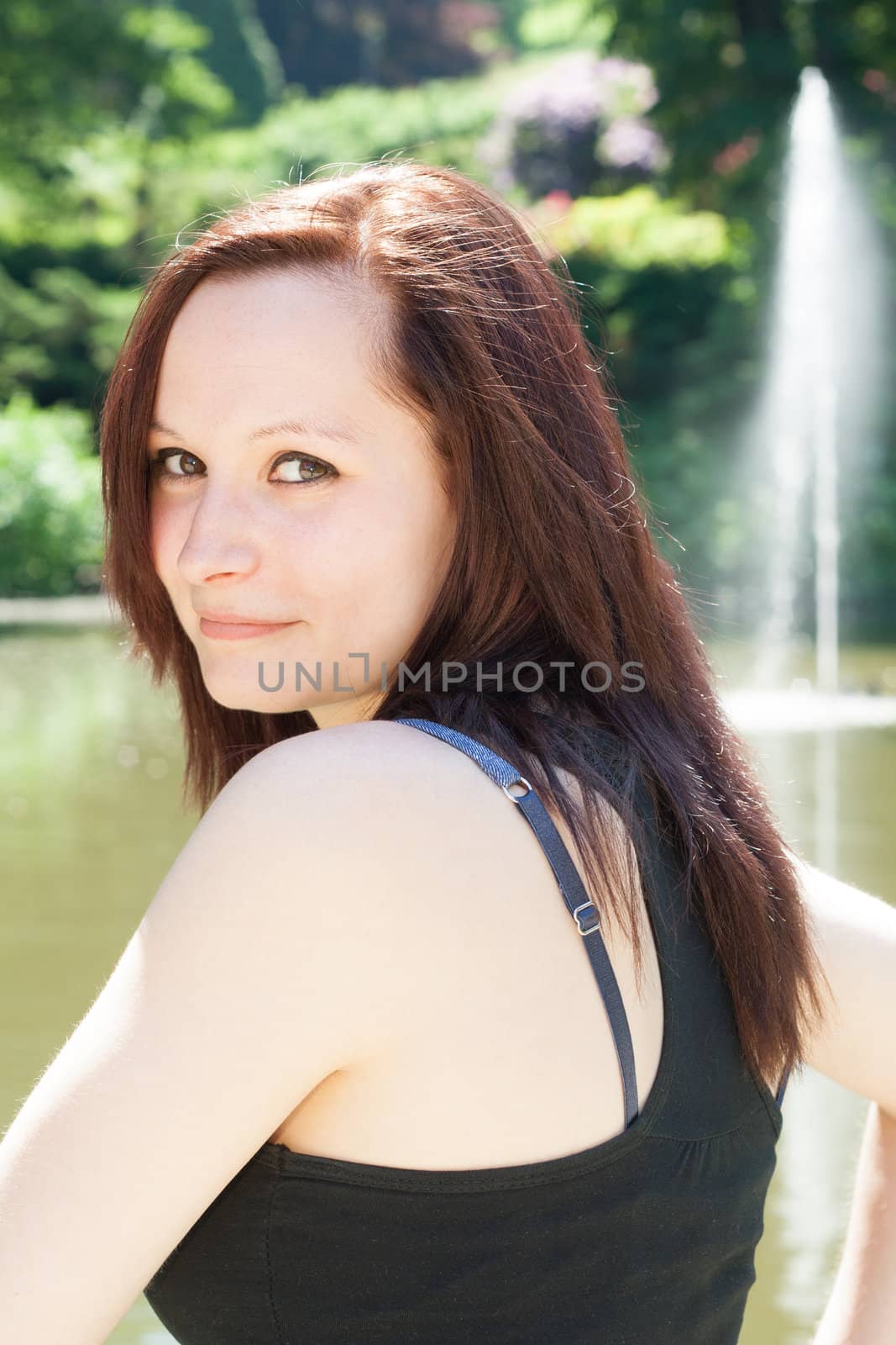 Portrait of an young  Redhead Girl outdoors in a park