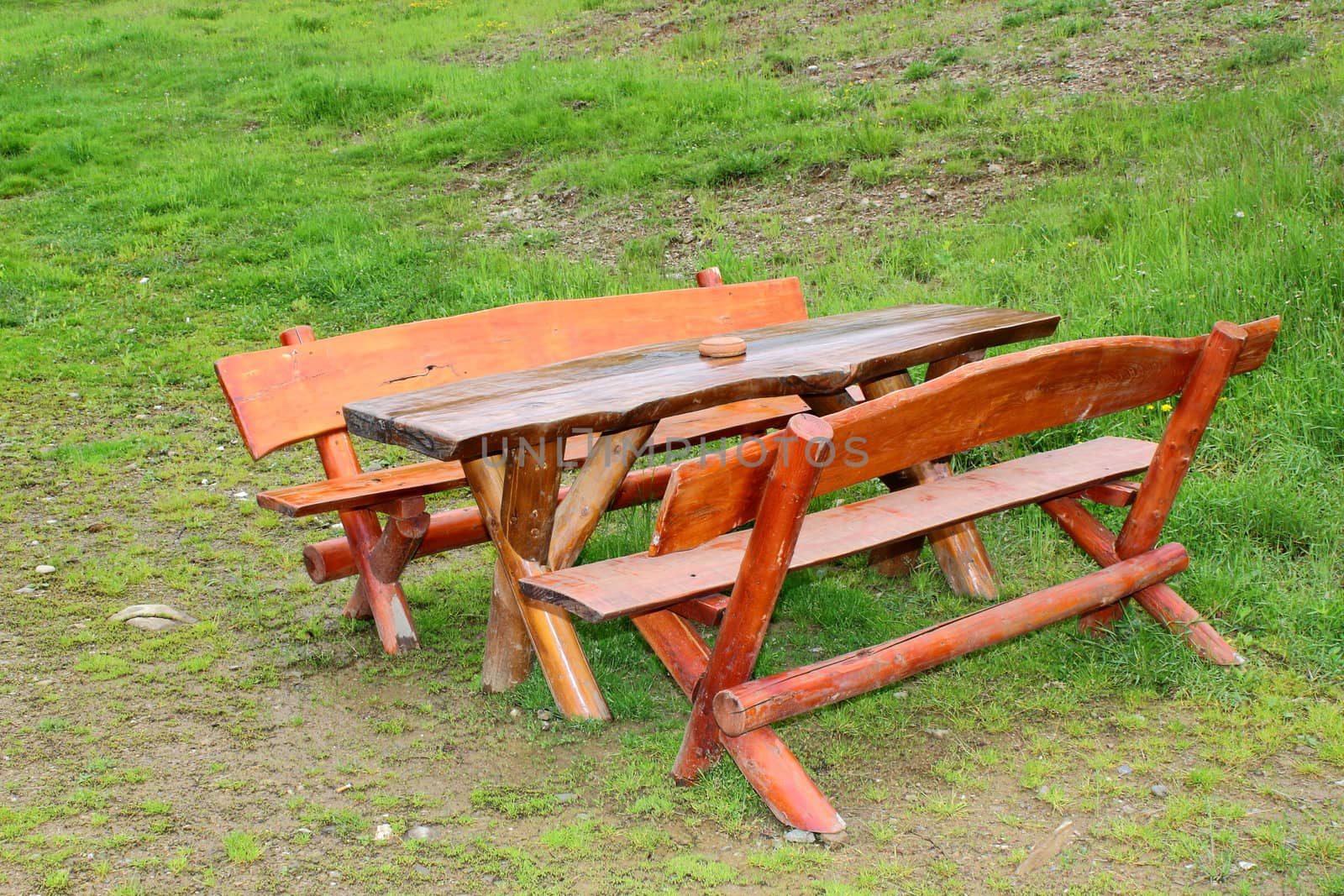 outdoor wooden bench near a lodge in the mountains