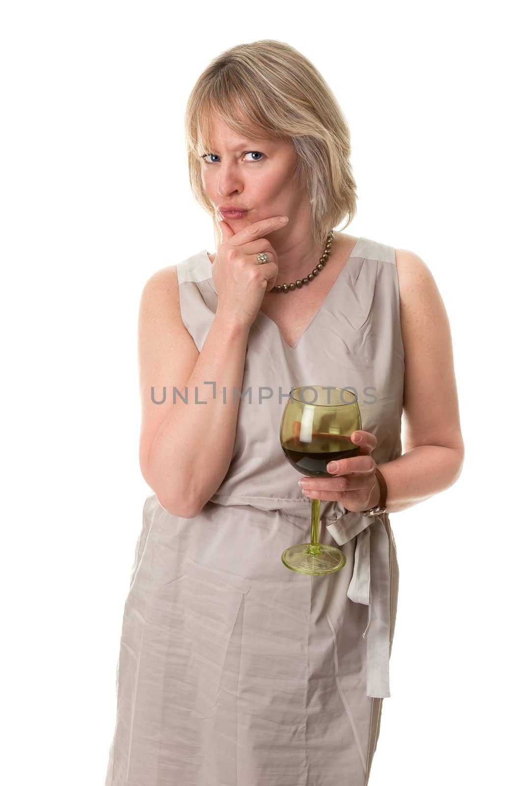 Attractive Mature Woman Pursing Lips in Thought with Hand to Face Holding Wine Glass Isolated